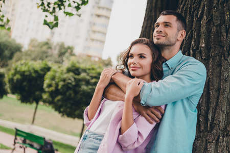 Photo of two lovely peaceful partners hugging enjoy each other spend free time walk outdoorsの写真素材