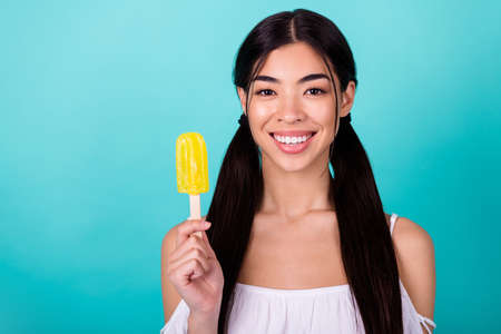Photo of funny shiny lady wear white top holding frozen fruit ice empty space isolated turquoise color backgroundの写真素材