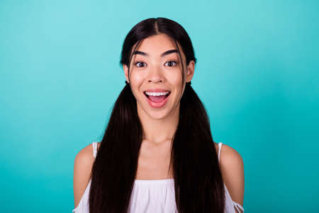Photo of astonished adorable filipino lady open mouth cant believe isolated on teal color backgroundの写真素材