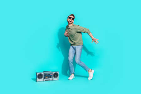 Full length photo of 80s motion disco dancer boom box fun wear pullover isolated blue color backgroundの写真素材