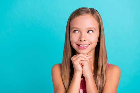 Photo of adorable tricky little lady dressed dotted sarafan looking empty space smiling isolated...