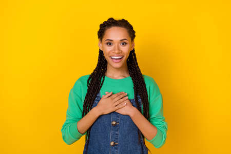 Photo of fascinated positive person arms touch chest unexpected isolated on yellow color background