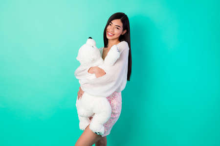 Photo of nice lady cuddle hug white bear toy boyfriend romantic present wear short skirt isolated cyan color backgroundの写真素材