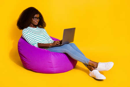 Full size photo of attractive lady sitting bag use wireless netbook coworking isolated on yellow...