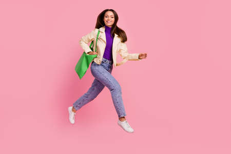 Full body profile photo of cute millennial lady run wear bag casual cloth sneakers isolated on pink...