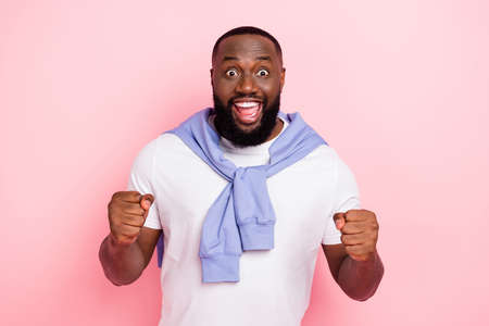 Photo of young crazy good mood man watch his favorite football team win isolated on pink color backgroundの写真素材