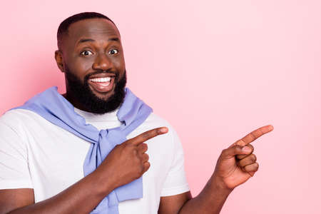 Portrait of cheerful wealthy millionaire man promote recommend shopping coupon isolated on pink color backgroundの写真素材