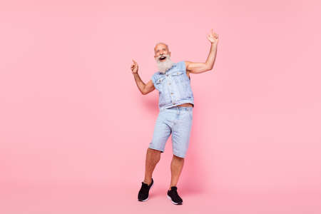 Full length photo of charming cute man pensioner dressed denim vest dancing having fun isolated pink color backgroundの写真素材