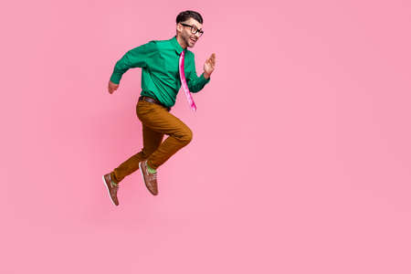 Full length photo of hurrying pretty man dressed green shirt eyewear jumping running fast empty...
