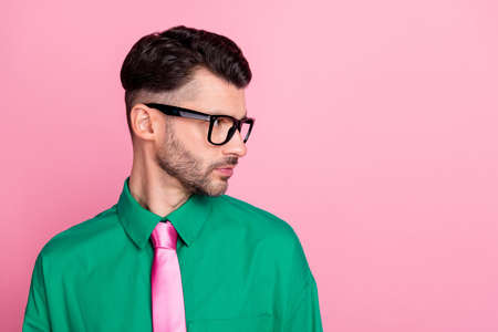 Photo of serious confident man dressed green shirt eyewear looking empty space isolated pink color...