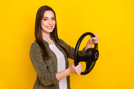 Photo of young attractive girl taxi rider hold steering wheel ride to pick up passenger isolated on...