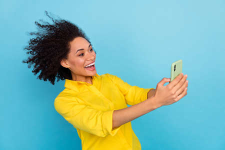 Profile photo of crazy funky lady use telephone chatting typing blog post isolated on blue color...