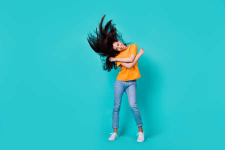 Full size photo of funky brunette lady dance wear t-shirt jeans boots isolated on turquoise color...