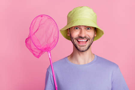 Photo of impressed satisfied guy hold net wear trendy violet clothes have fun summer season time...