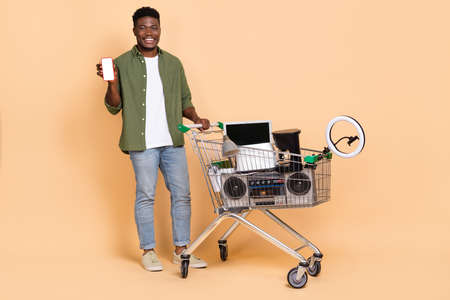 Photo of millennial guy show device recommend use web app sell recycle stuff isolated pastel color backgroundの写真素材