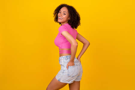 Profile photo of funny brunette young lady wear pink t-shirt shorts isolated on vivid orange color backgroundの写真素材