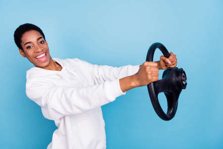 Photo of beautiful funky trans girl wear white sweatshirt riding auto transport isolated blue color backgroundの写真素材