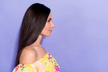 Profile portrait of lovely calm person look empty space isolated on pastel purple color backgroundの写真素材