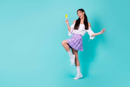 Full size photo of positive college lady enjoy refreshment fruit popsicle wear top long socks...