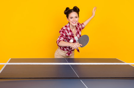 Photo of adorable cute lady trainer show how practice ping pong game use racquet ball isolated bright color backgroundの写真素材