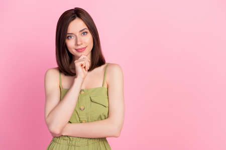 Photo of attractive nice thoughtful girl bob hairdo wear khaki overall finger on chin shopping decision isolated on pink color backgroundの写真素材
