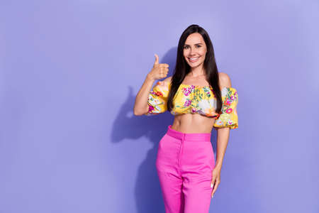 Portrait of pretty positive girl arm finger show thumb up rate toothy smile isolated on purple color backgroundの写真素材