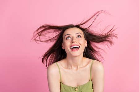 Portrait of attractive cute shine cheerful girl wear khaki tank having fun throwing hair copy space isolated on pink color backgroundの写真素材