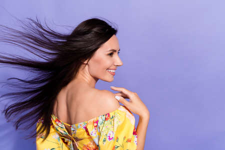 Photo of pretty lovely girl dressed off shoulders blouse wind blowing looking empty space isolated purple color backgroundの写真素材