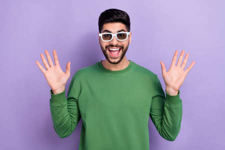 Photo of handsome positive optimistic excited man dressed green pullover hold palms look impressed...