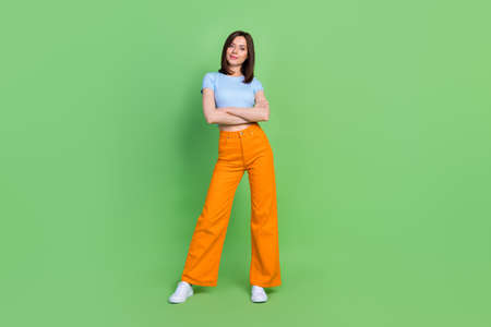 Full body size photo of young confident woman hold crossed hands looking you serious isolated on...