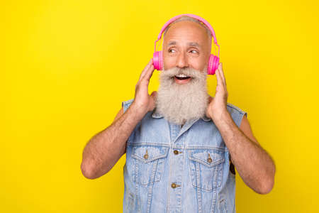 Photo of dreamy funny man pensioner dressed denim vest enjoying music looking empty space isolated...