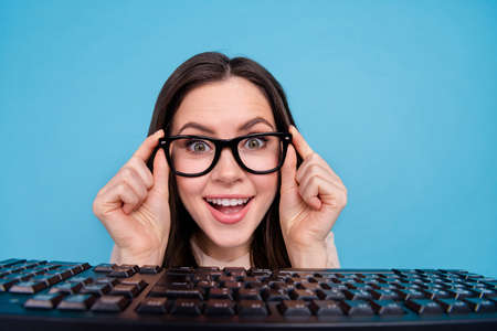 Portrait of positive impressed lady marketer look webcam pc technology read media news isolated blue...