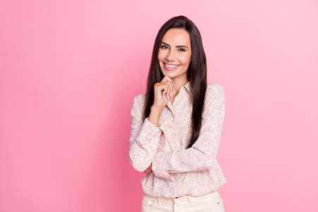 Closeup photo of young attractive lady smiling pose touch chin think new plan make money isolated on pink color backgroundの写真素材