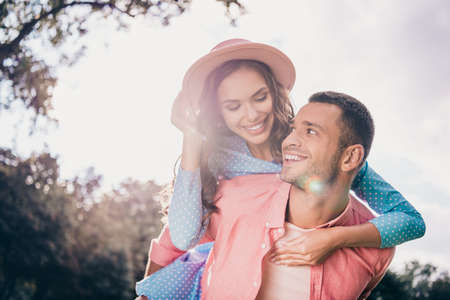 Photo of charming funny two people together wear casual outfits walking riding arms outside gardenの写真素材