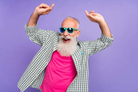 Portrait of positive excited person have fun dancing good mood feel young isolated on purple color...
