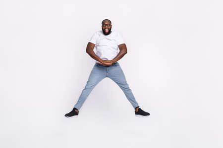 Photo of funky pretty man wear casual t-shirt eyewear smiling jumping high isolated white color...