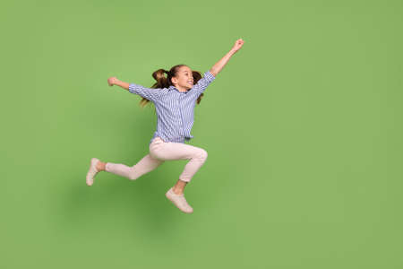 Profile side photo of carefree active child girl jump run fast rush save hero world isolated shine...