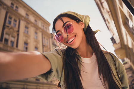 Photo of cheerful positive pretty person male selfie toothy smile sunny warm weather outside