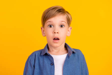 Portrait of impressed confused person open mouth stare speechless isolated on yellow color backgroundの写真素材