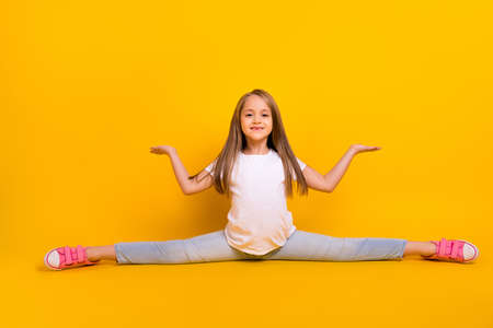 Full length photo of pretty funky school girl wear white t-shirt sitting split legs compering arms...