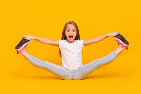 Full length photo of funky pretty schoolgirl dressed white t-shirt sitting floor split legs isolated...
