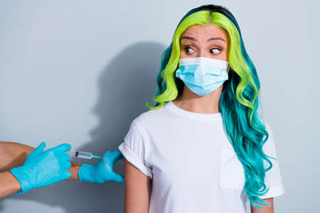 Photo of nervous vibrant gradient hair girl dressed t-shirt corona virus respirator looking empty space isolated white color backgroundの写真素材