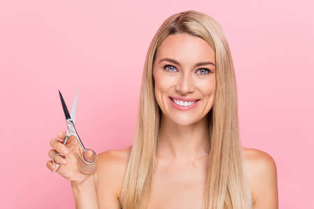Photo of joyful lady hold scissors prepare party beauty hairstylist salon isolated over pastel pink...