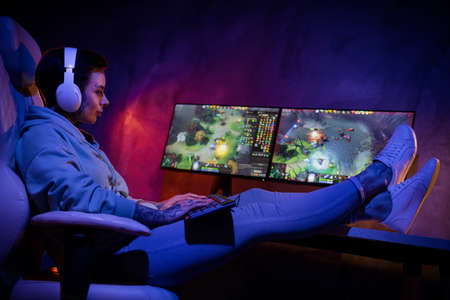 Full body profile photo of pretty gamer girl sitting chair hold keyboard dark room computer club...