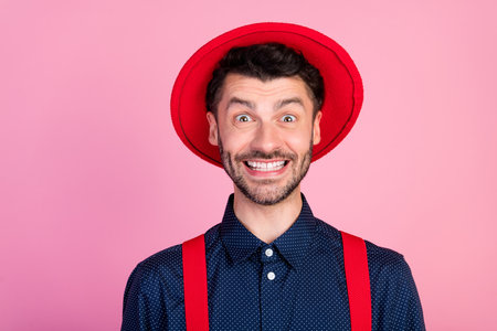 Photo of crazy cheerful person toothy beaming smile wear red hat isolated on pink color backgroundの写真素材