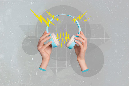 Hands holds headphone isolated on painting grey color backgroundの写真素材