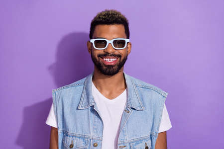 Photo of cool funny guy dressed denim vest dark eyewear smiling isolated purple color background