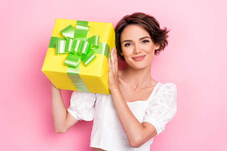 Photo of sweet shiny lady wear white blouse smiling rising present box isolated pink color...