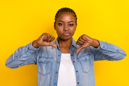 Photo of sad lady not recommend adverts shopping sale make thumb down isolated bright color backgroundの写真素材