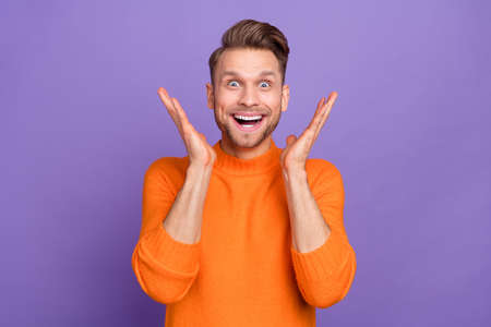Photo of good mood overjoyed man cant believe his eyes see huge sale discount promo isolated on purple color backgroundの写真素材